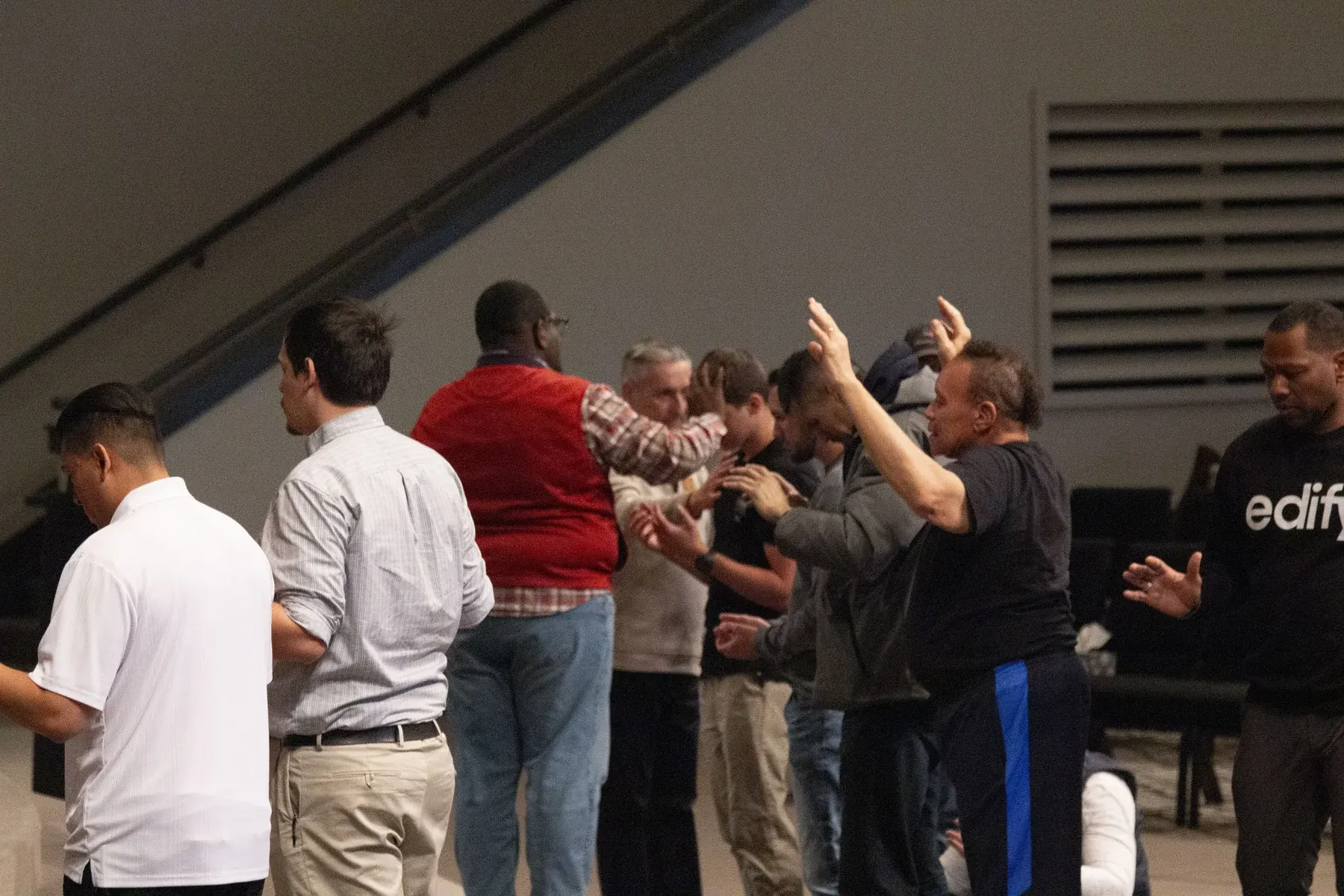 Group of people gathering indoors for a meeting or event in a modern facility